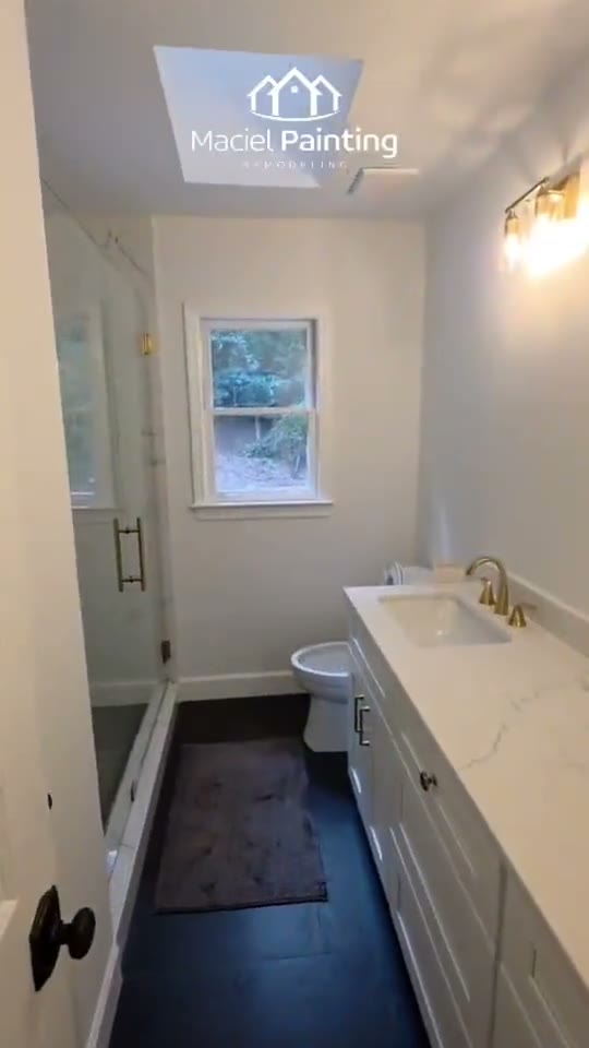 Finished bathroom repaint with clean white trim, Marietta